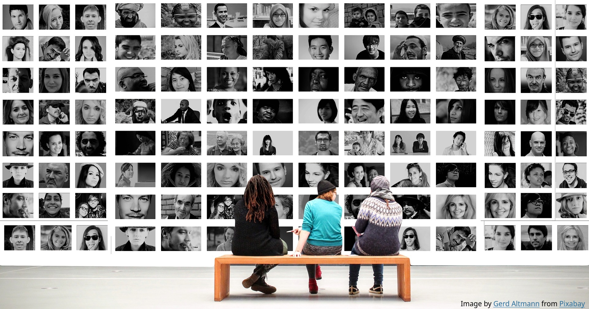 Three people sitting in front of the wall of portraits photographies. Image by Gerd Altmann from Pixabay.